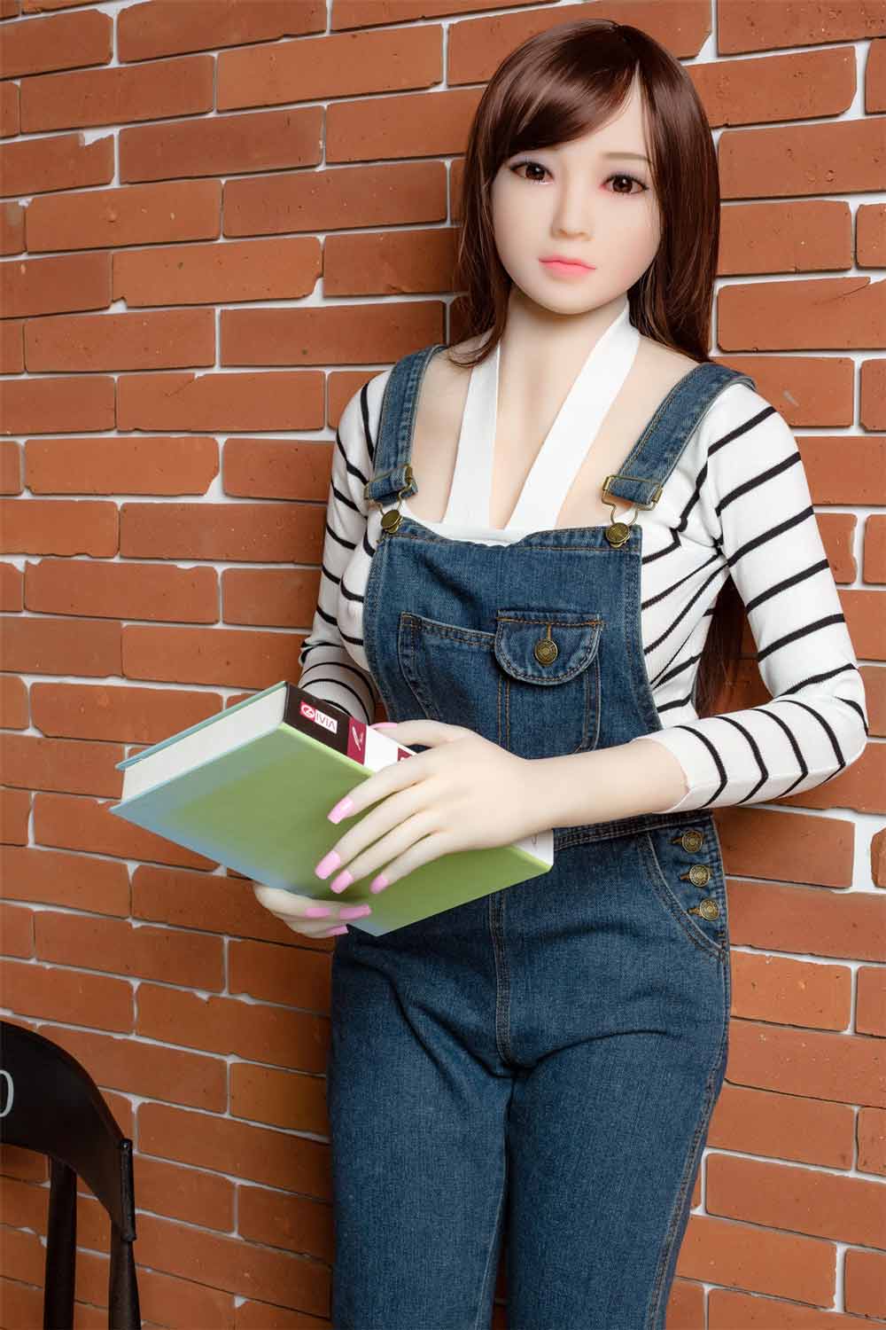 Sex doll with book in both hands